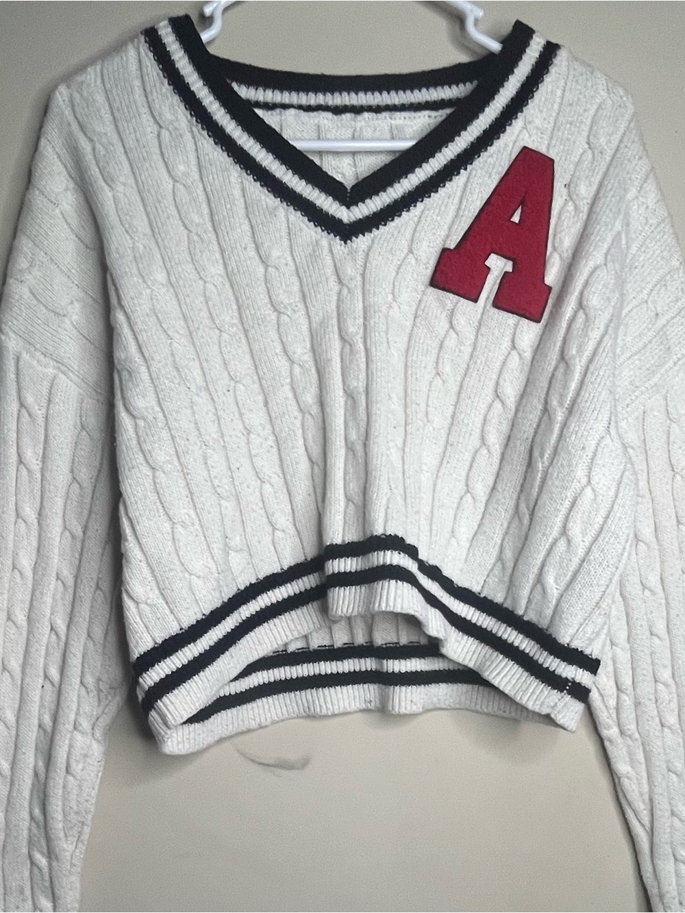SHEIN Cream Cable-Knit V-Neck Sweater with Black Trim and Red Patch
